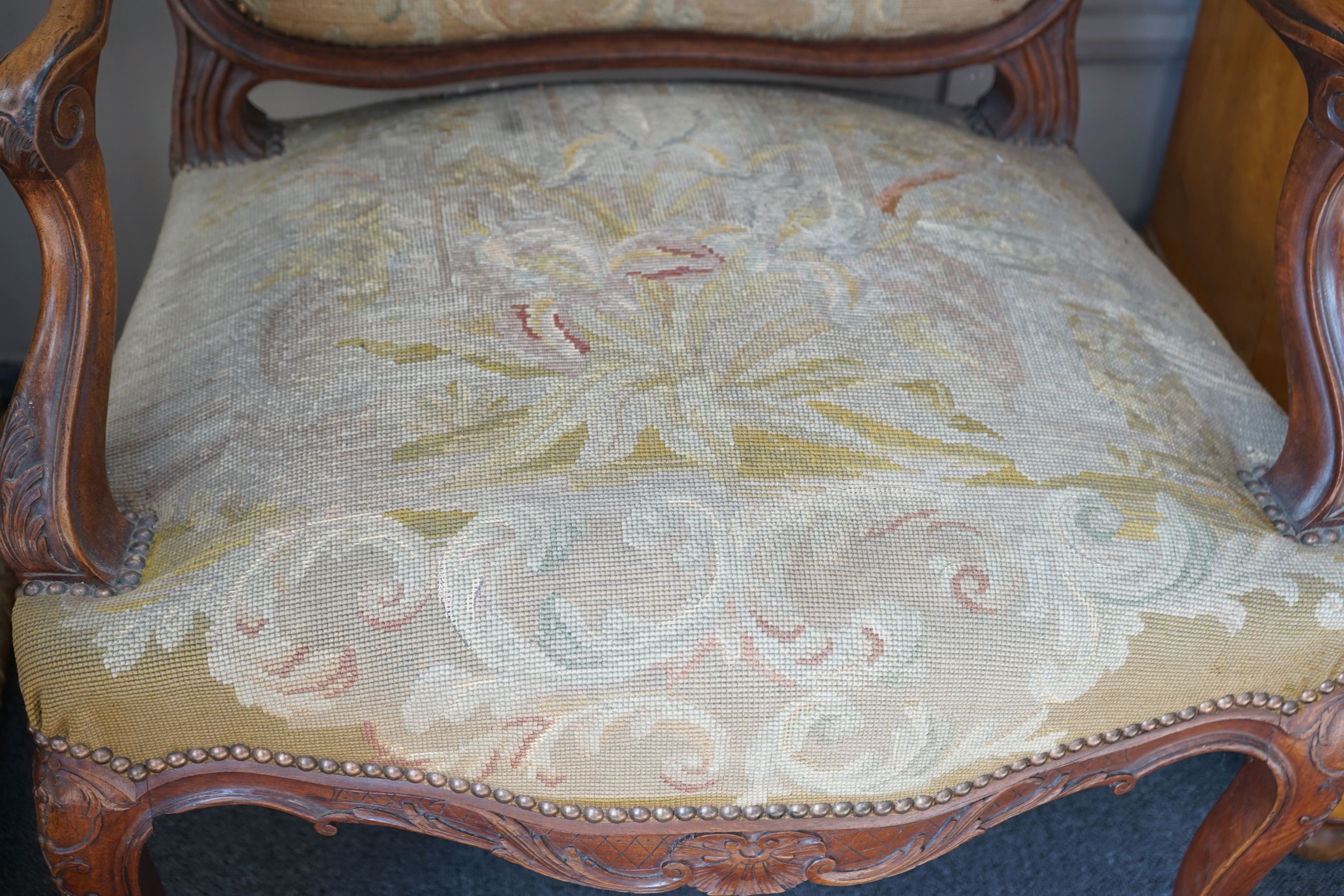 A pair of French carved walnut fauteuils with tapestry upholstery, width 75cm, depth 62cm, height 120cm